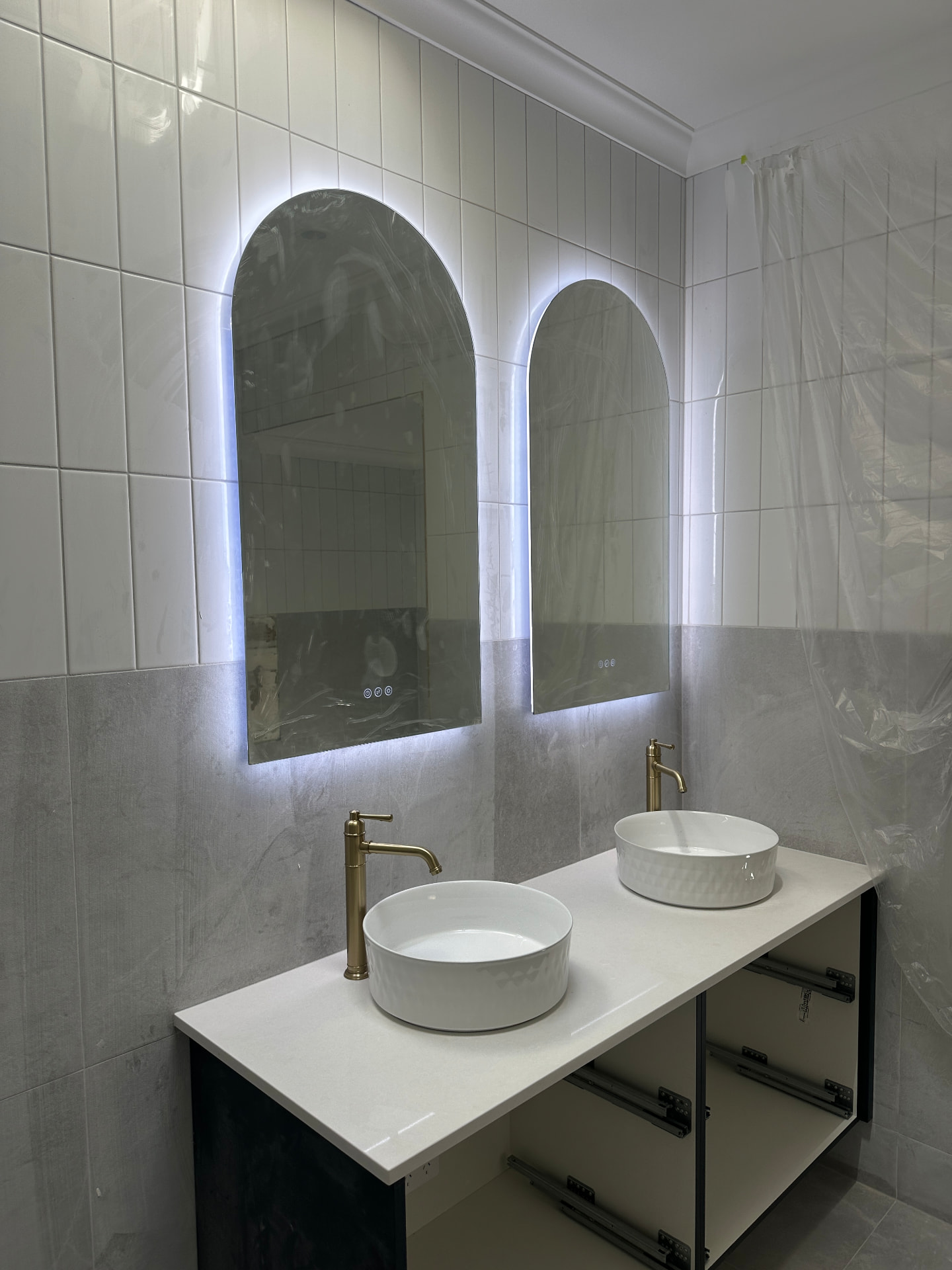 Backlit arched mirrors