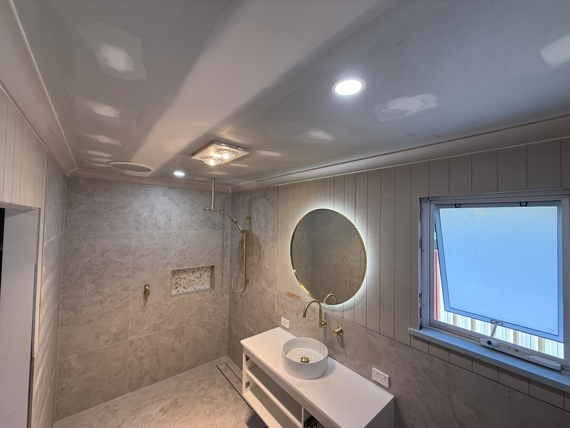 Bathroom renovation with LED mirror and downlights